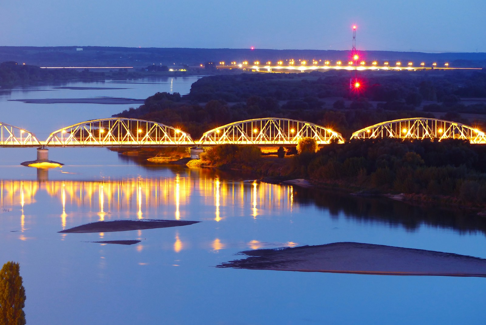 a bridge over a river at night